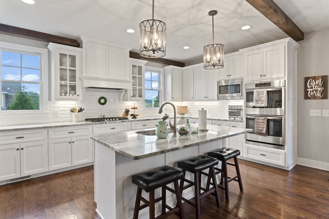 kitchen featuring appliances with stainless steel finishes, dark wood-type flooring, and white cabinetry