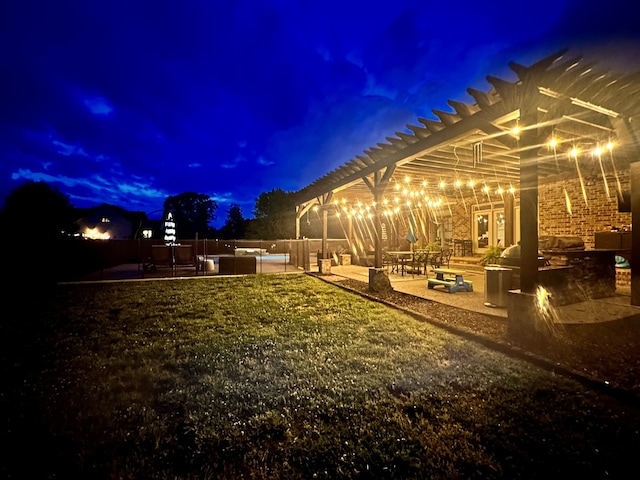 yard at twilight with a pergola and a patio