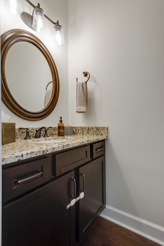 bathroom featuring wood-type flooring and vanity