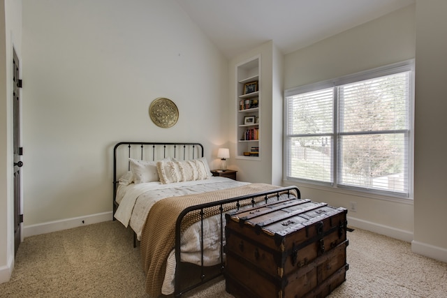 bedroom with lofted ceiling, light colored carpet, and multiple windows