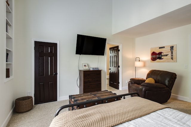 bedroom with light colored carpet and a high ceiling