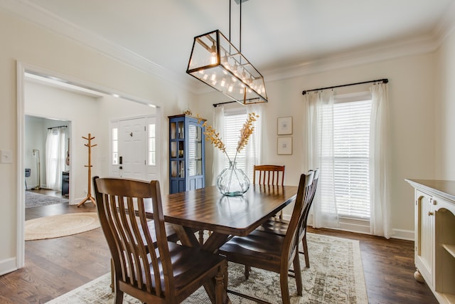 dining room featuring dark hardwood / wood-style flooring, crown molding, and a chandelier