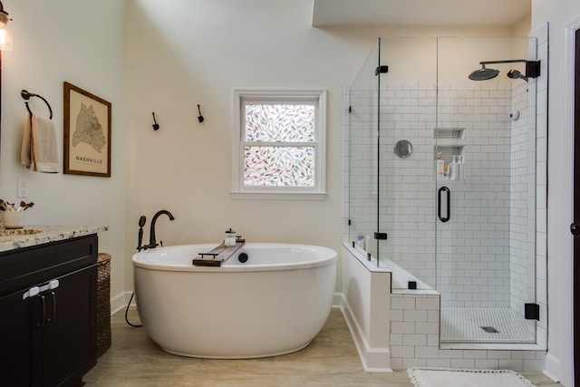 bathroom with tile flooring, vanity, and independent shower and bath