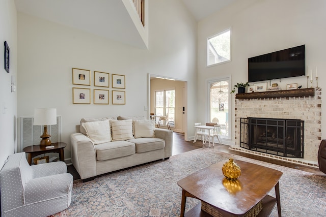 living room with high vaulted ceiling, dark hardwood / wood-style flooring, and a brick fireplace