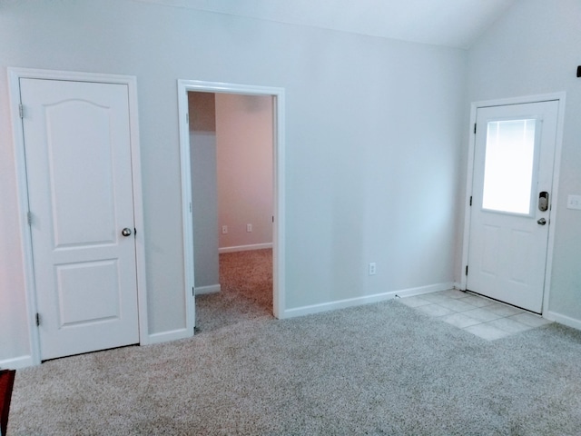 interior space featuring lofted ceiling and light colored carpet