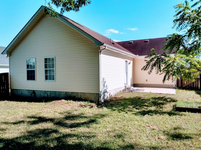 view of property exterior featuring a yard and a patio