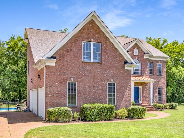 view of front facade featuring a front yard and a garage