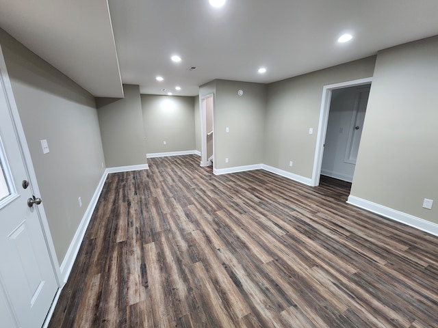 basement with dark hardwood / wood-style floors