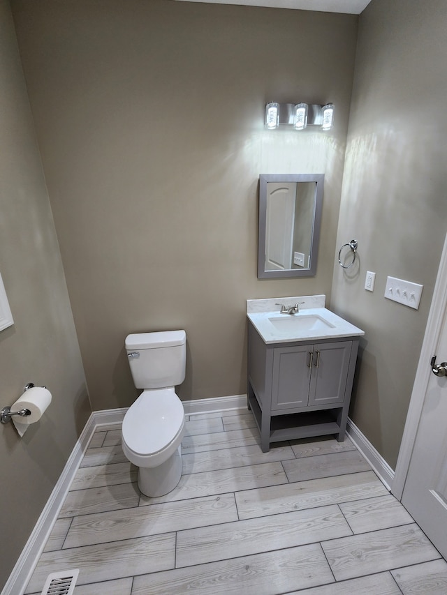 bathroom with toilet and vanity