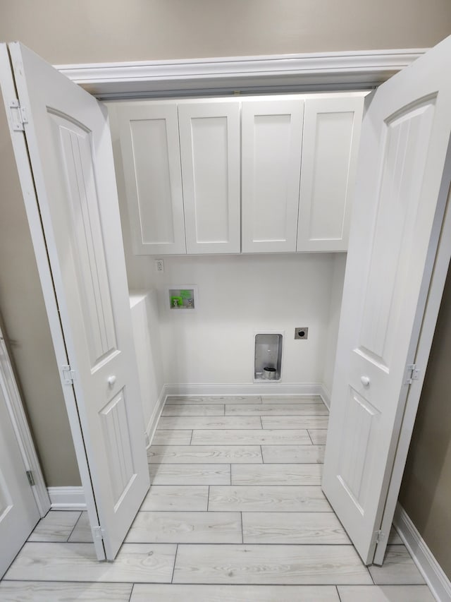 washroom with cabinets, electric dryer hookup, and hookup for a washing machine