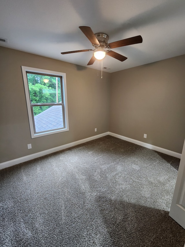 carpeted empty room featuring ceiling fan