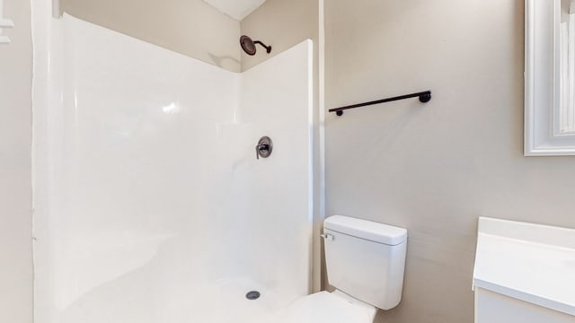 bathroom with walk in shower and toilet