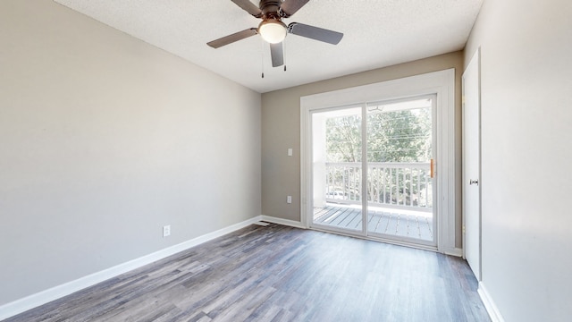 unfurnished room featuring ceiling fan, a textured ceiling, and dark wood-type flooring