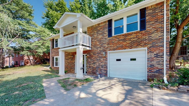 view of front of home featuring a front lawn, a balcony, and a garage