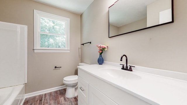 full bathroom with hardwood / wood-style floors, oversized vanity, toilet, and tub / shower combination