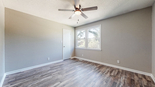 empty room featuring a textured ceiling, ceiling fan, and dark hardwood / wood-style flooring