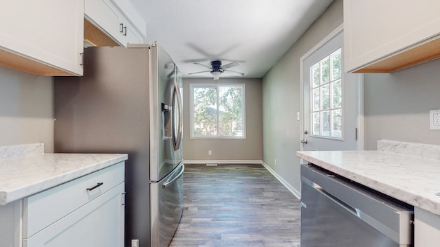 kitchen with plenty of natural light, dark hardwood / wood-style flooring, ceiling fan, and appliances with stainless steel finishes