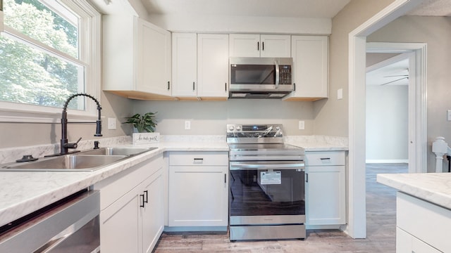 kitchen featuring white cabinetry, appliances with stainless steel finishes, and sink