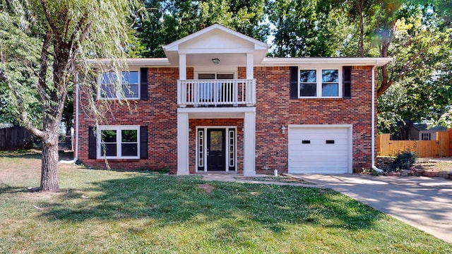 view of front facade with a front yard, a balcony, and a garage