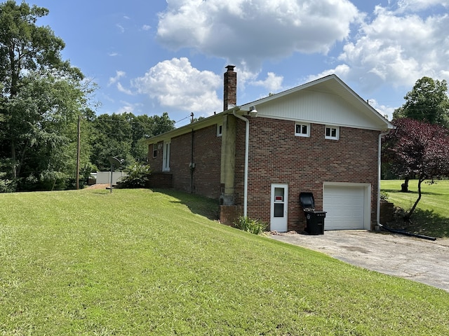 view of side of property with a lawn and a garage