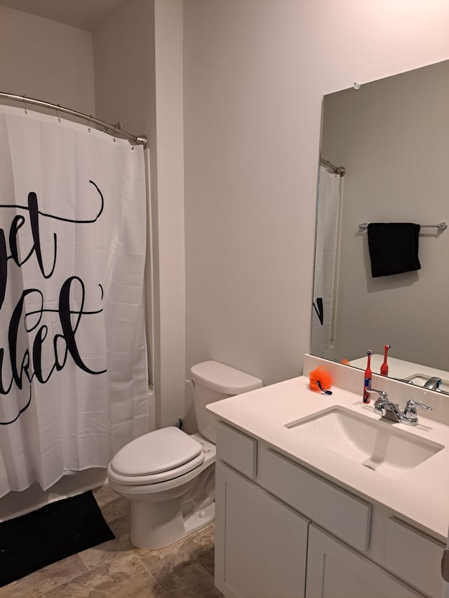 bathroom featuring large vanity, tile floors, and toilet