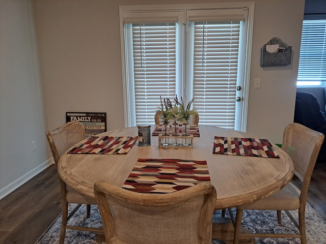 dining area featuring dark wood-type flooring