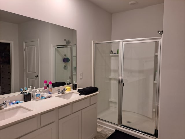 bathroom with double sink, oversized vanity, tile flooring, and an enclosed shower