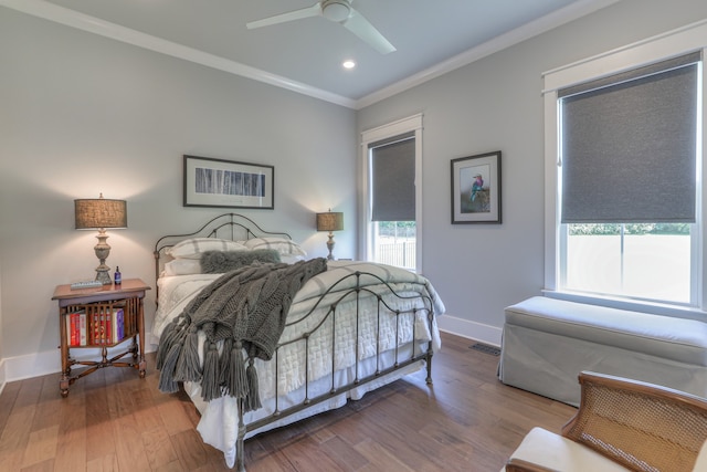 bedroom with ceiling fan, crown molding, and dark hardwood / wood-style floors