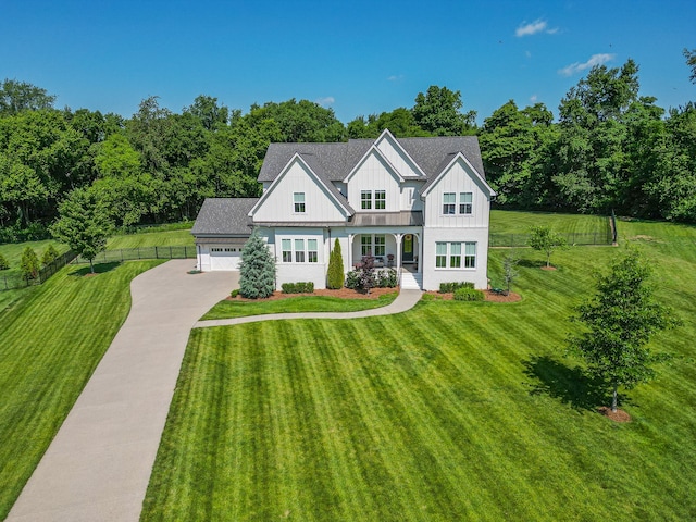 view of front of house featuring a front lawn and a garage