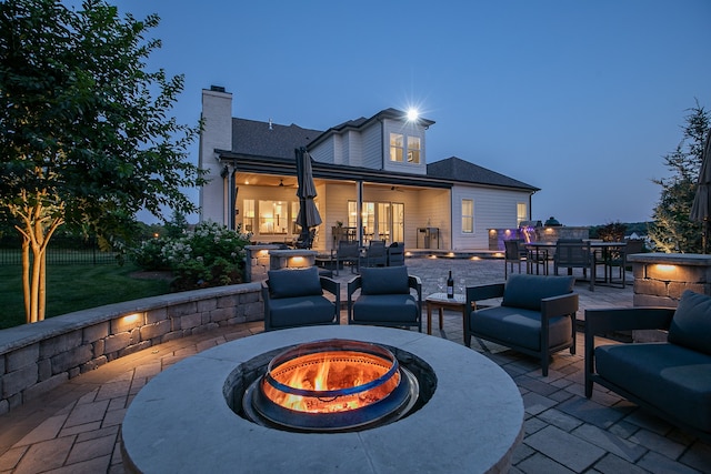 view of terrace featuring an outdoor living space with a fire pit