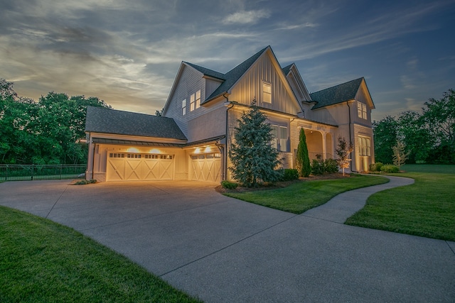 view of front of property with a yard and a garage