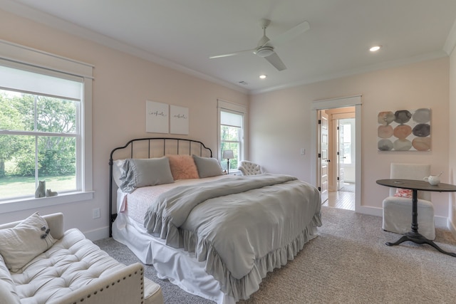 carpeted bedroom featuring ceiling fan and ornamental molding