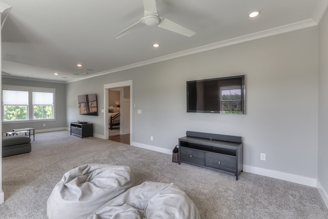 living room featuring light carpet, ornamental molding, and ceiling fan