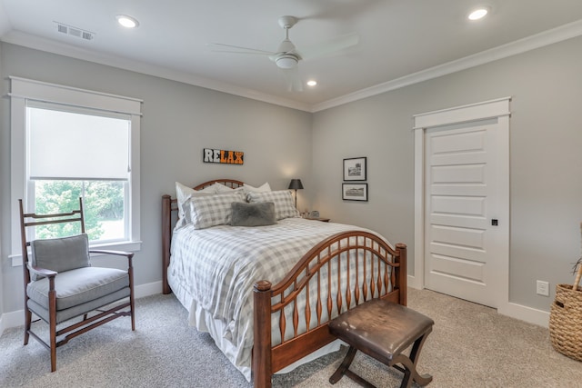 carpeted bedroom featuring crown molding and ceiling fan