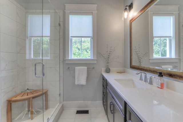 bathroom with walk in shower, tile flooring, and vanity