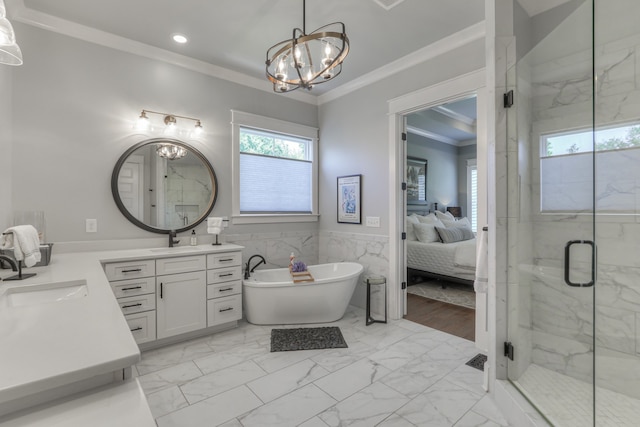 bathroom with independent shower and bath, a notable chandelier, wood-type flooring, vanity with extensive cabinet space, and crown molding