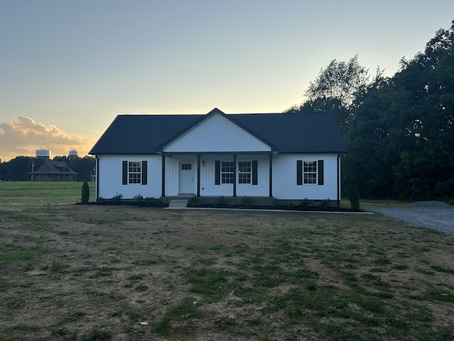 view of front of house featuring a yard and covered porch