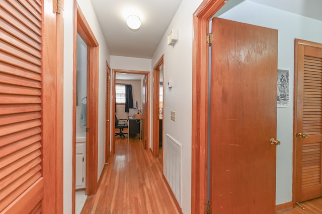 hall with light hardwood / wood-style flooring