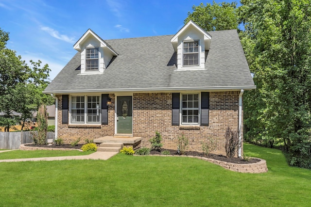 new england style home featuring a front lawn