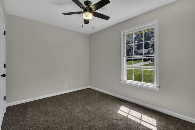 carpeted spare room with ceiling fan and a textured ceiling