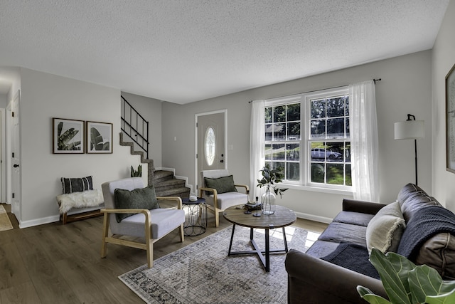 living room with dark hardwood / wood-style floors and a textured ceiling