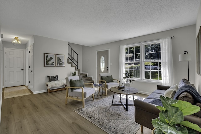 living room featuring a textured ceiling and light hardwood / wood-style flooring