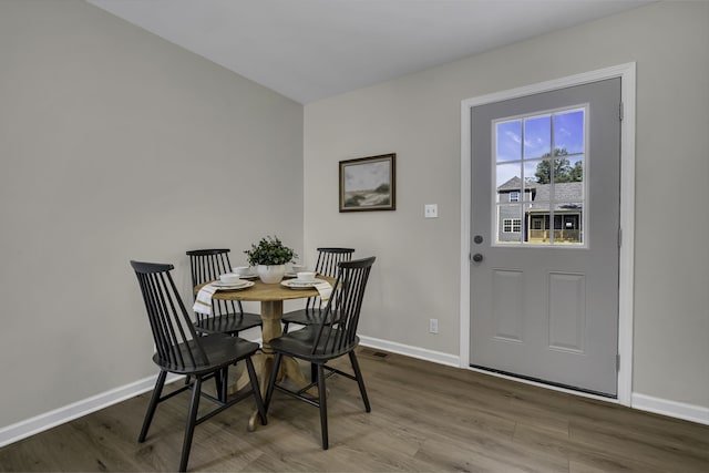 dining space with dark wood-type flooring