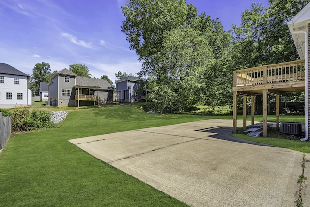 view of yard with a deck and central AC