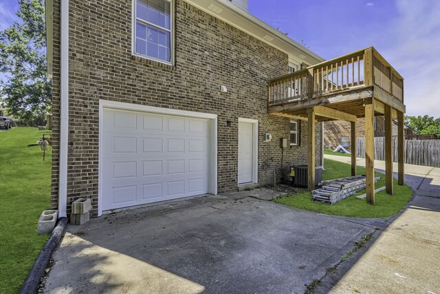 view of front of house featuring a wooden deck, a front lawn, and a garage