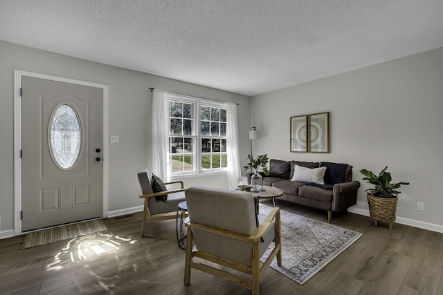 living room featuring a textured ceiling and dark wood-type flooring