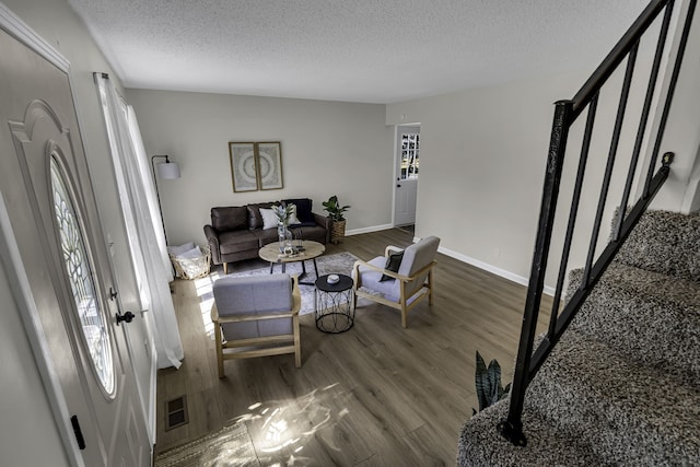 dining area with dark hardwood / wood-style flooring and a textured ceiling