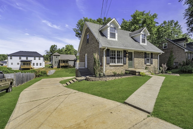 cape cod home with a front yard