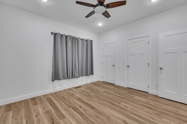 empty room featuring ceiling fan and light wood-type flooring