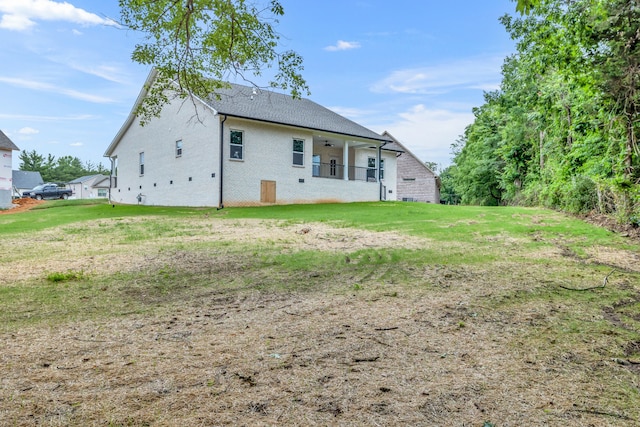 rear view of house featuring a yard